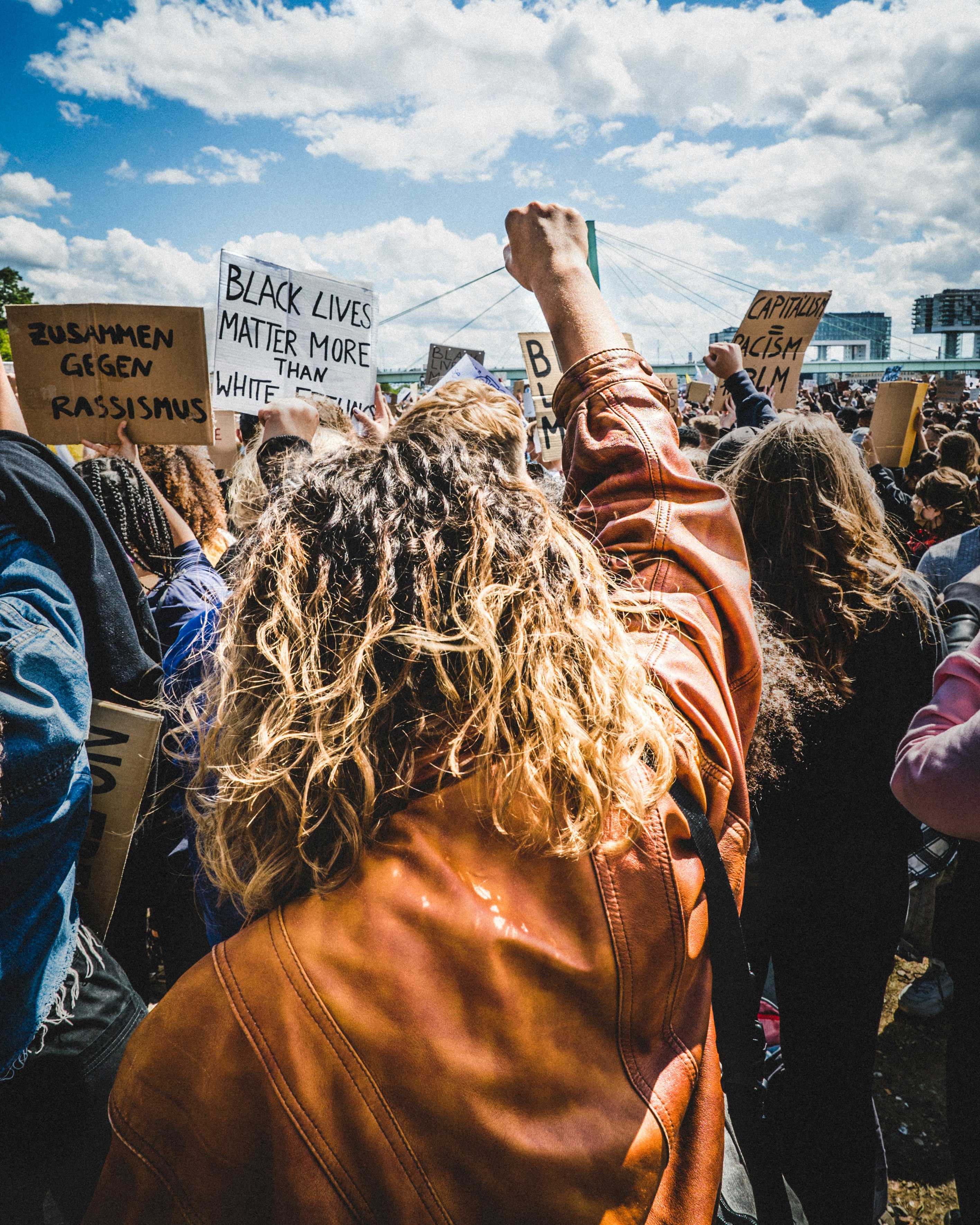 woman in brown long sleeve shirt raising her hands